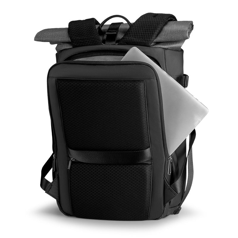 Black large-capacity camera backpack with textured front panel, laptop partially visible in main compartment, multiple zippers and padded straps for travel.