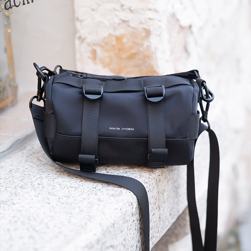 Mark Ryden black cylinder crossbody bag with straps, anti-theft style