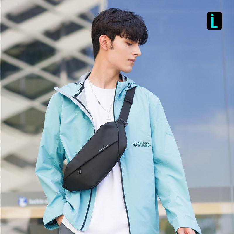 Black MetroFlex crossbody bag with GORE-TEX INFINIUM, worn by man in light blue jacket - urban setting