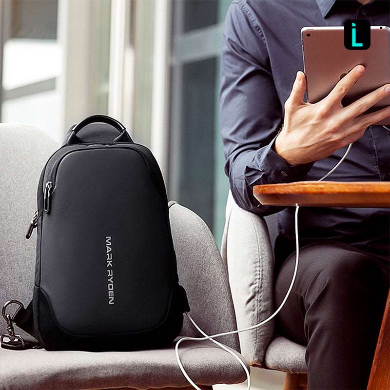Mark Ryden Mini Julius black crossbody bag with USB charging cable, modern travel setting
