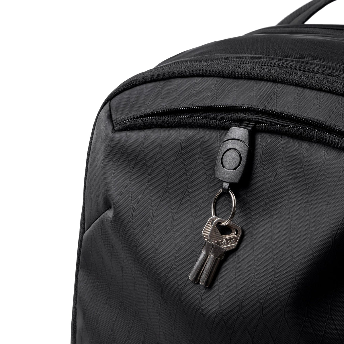 Black textured MARK RYDEN Global travel backpack zipper with key ring and keys