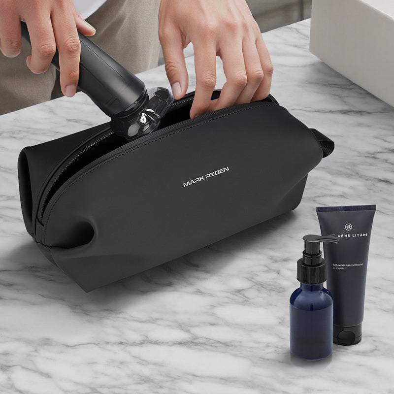 Mark Ryden modern black PU toiletry bag with toiletries on marble surface