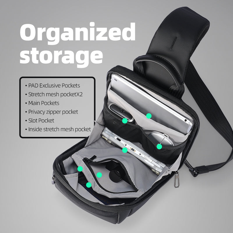 Black StealthChest RFID-secure chest bag for urban operator, open showing organized storage with PAD Exclusive Pockets, stretch mesh pockets, main pockets, privacy zipper pocket, slot pocket, and inside stretch mesh pocket holding a tablet.