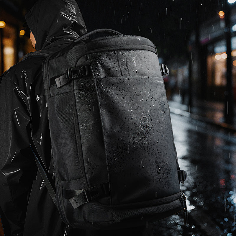 Mark Ryden Global Aegis Fortress 38L all-weather backpack shown in rainy urban setting