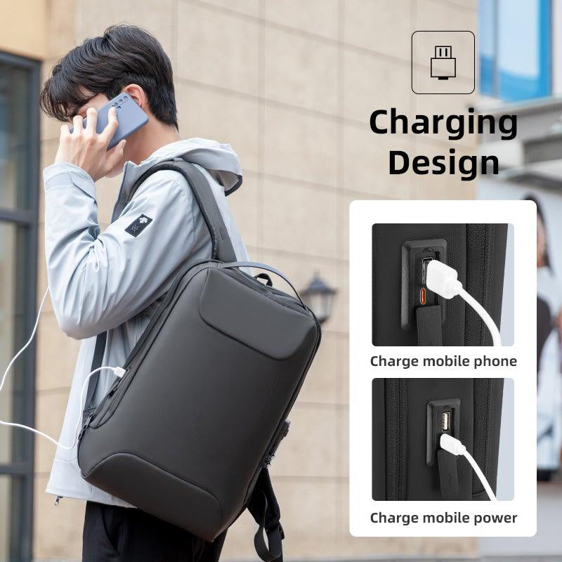 Man wearing dark gray Compilo Oxford anti-theft laptop backpack with USB charging port, demonstrating charging mobile phone and power bank.