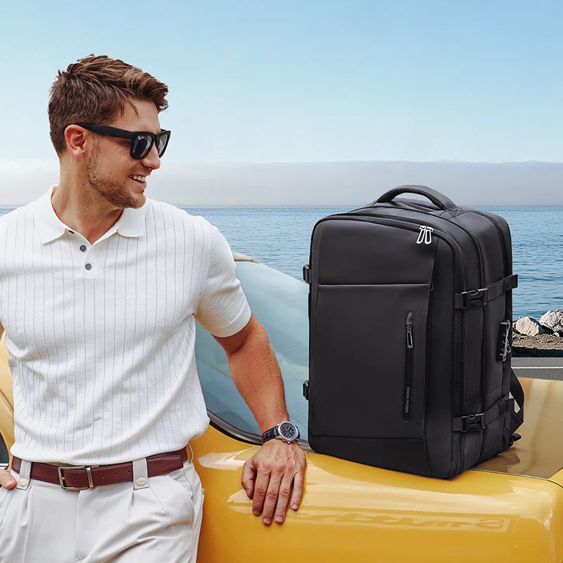 MARK RYDEN Expandos Max anti-theft compression backpack on yellow car by ocean
