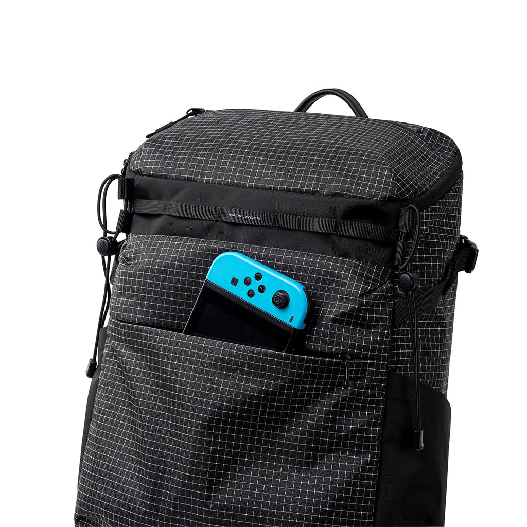 Black grid-patterned Mark Ryden AeroPro 17.3" laptop backpack with blue gaming controller in front pocket