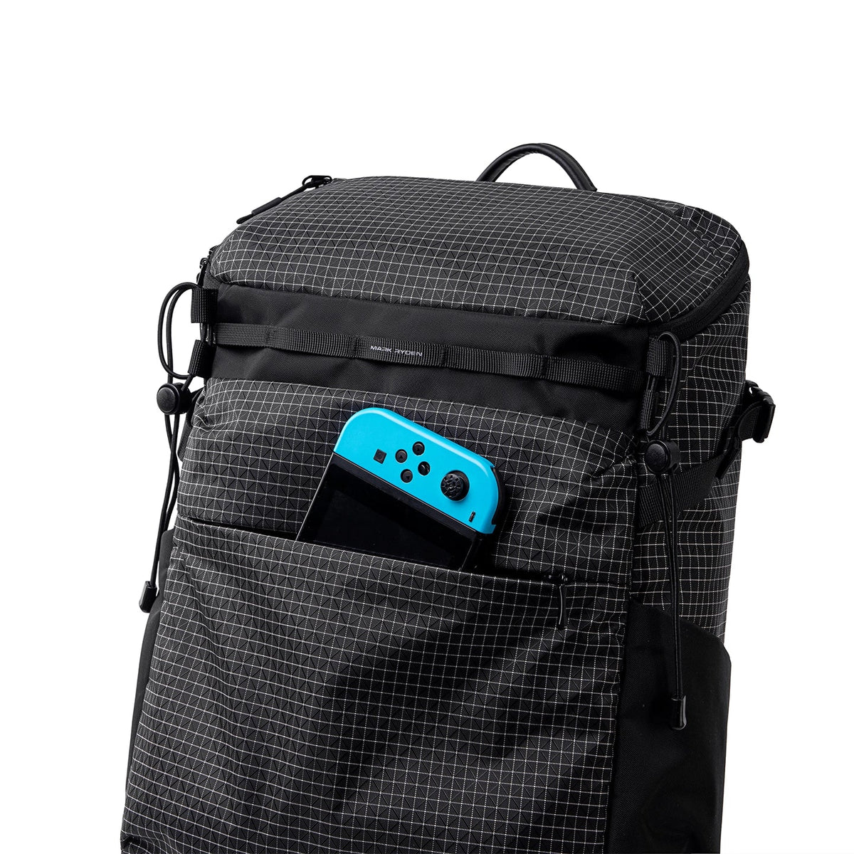 Black grid-patterned Mark Ryden AeroPro 17.3" laptop backpack with blue gaming controller in front pocket