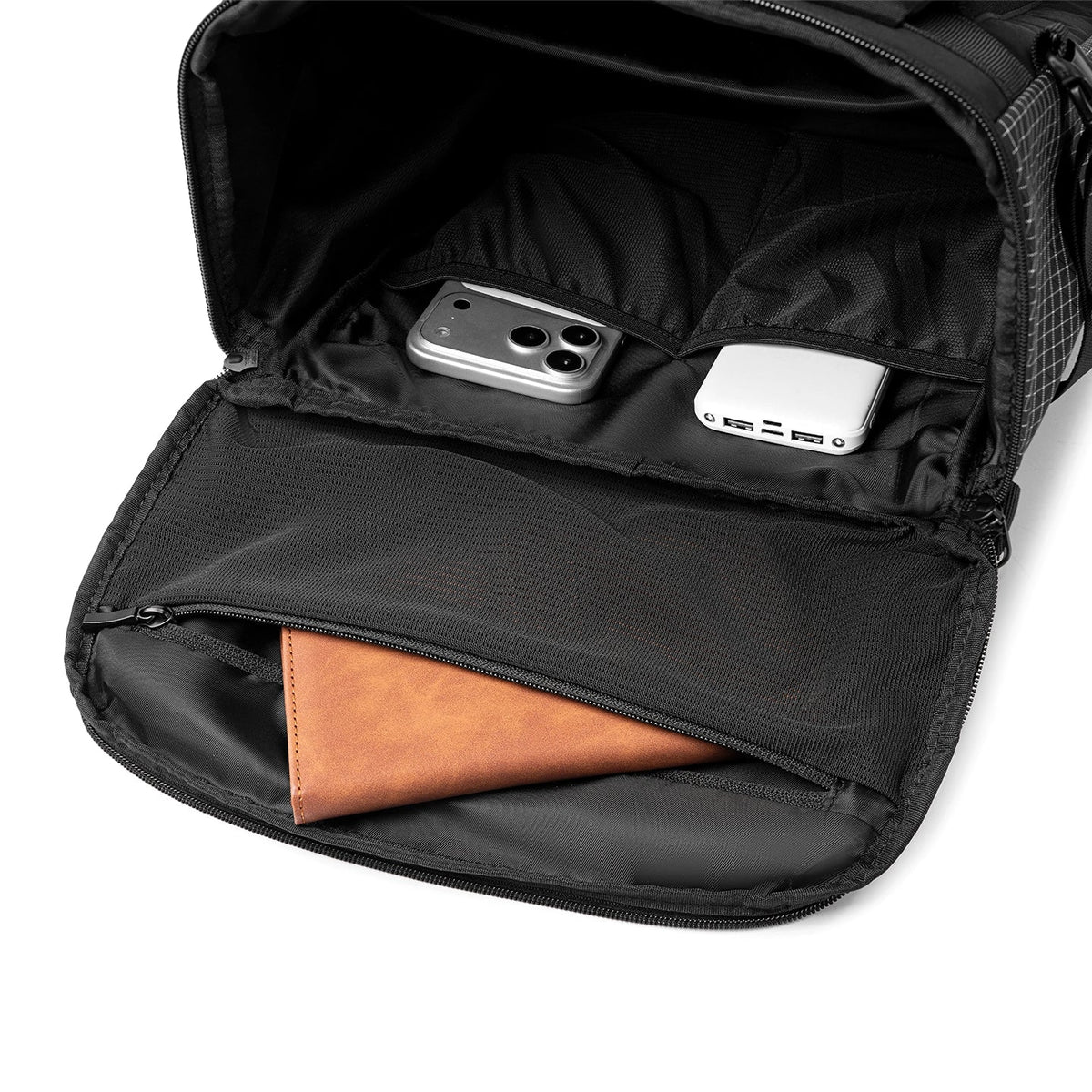 MARK RYDEN Global AeroPro 17.3" laptop backpack interior with compartments holding phone, power bank, wallet