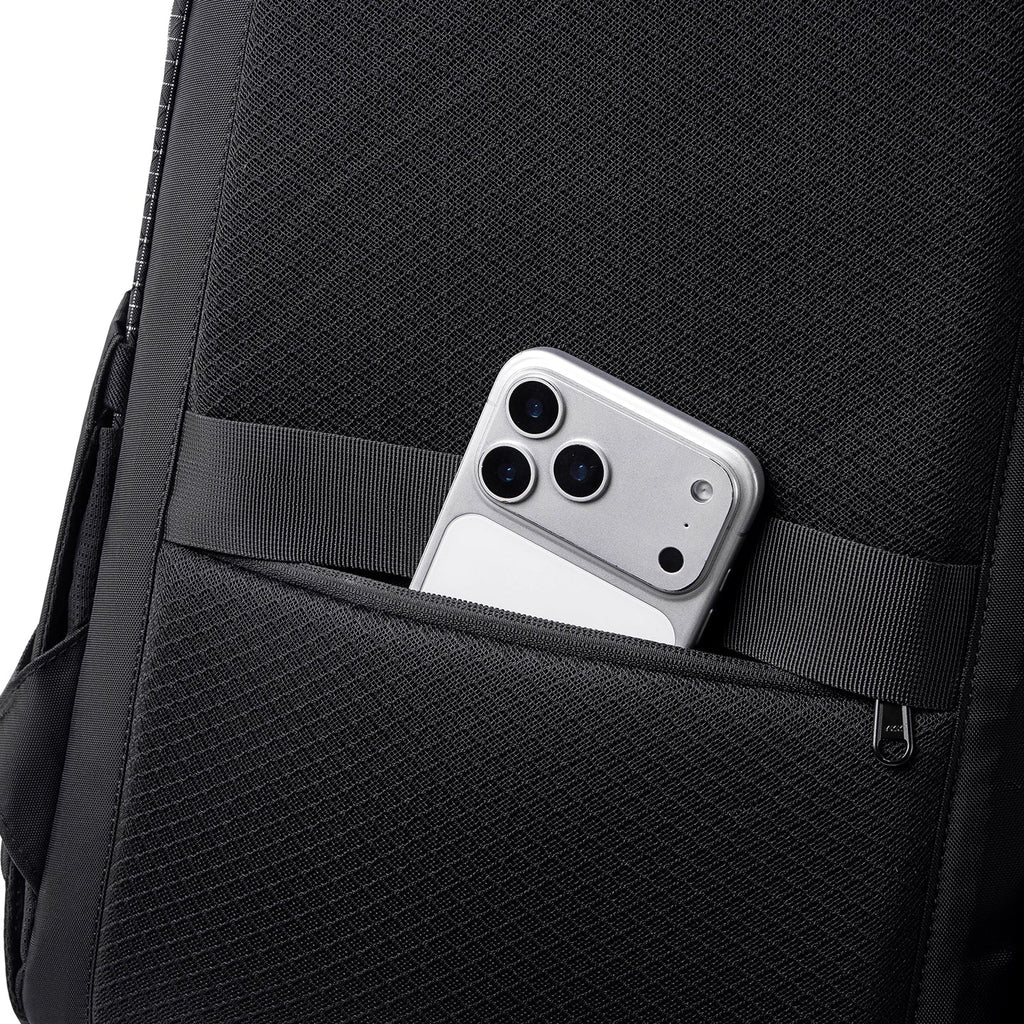 Black AeroPro 17.3" Laptop Backpack with textured fabric and a front pocket containing a silver smartphone, perfect for travelers.