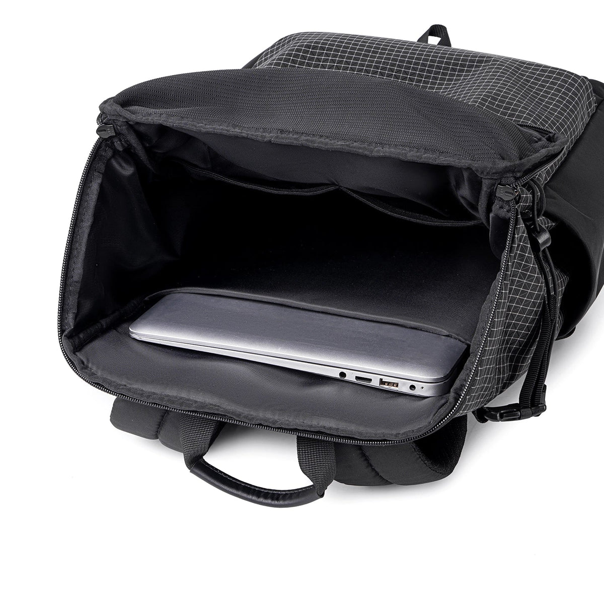 Black AeroPro 17.3" laptop backpack with gray grid pattern, open to show padded laptop compartment holding a silver laptop, designed for travelers with enhanced support.