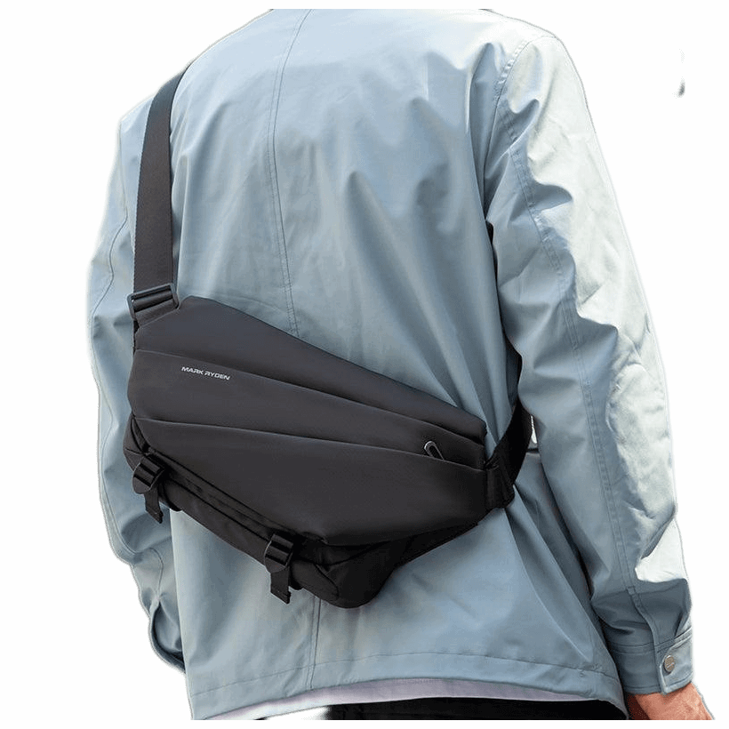 Black leather Voyager messenger bag with umbrella pocket by Mark Ryden, worn across the body on a person in a light blue jacket.